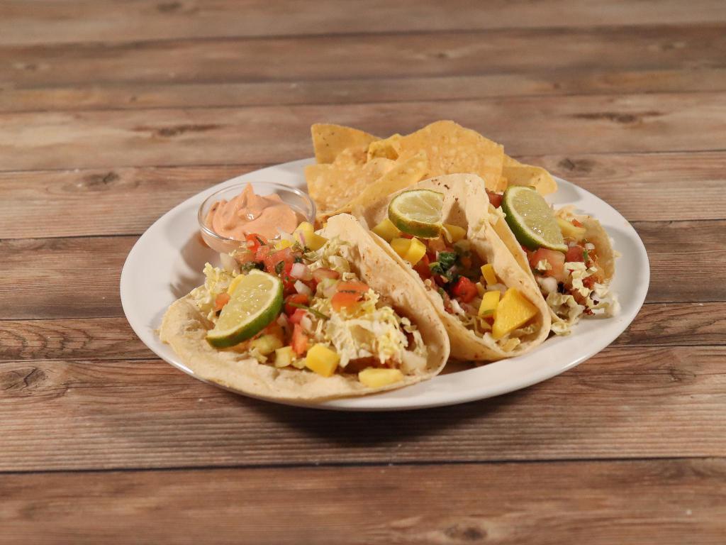 Chipotle Lime Fish Tacos · 3 tacos made with tilapia sauteed in adobo lime seasoning, topped with shredded cabbage, house-made pico de gallo, fresh diced mango and chipotle sour cream on white tortillas. Served in a basket with chips and salsa.