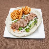 Beef Shawarma Pita · Juicy tender beef Shawarma wrapped in a pita served with fries