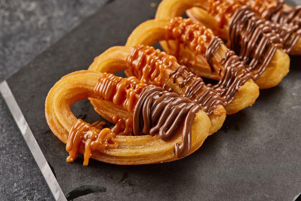 CHURROS · Crispy churros with Nutella and Dulce de leche.