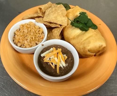 Chimichanga Plate · Hand-rolled chimi. Served with your choice of filling, fried golden
brown, topped with our zesty tomatoes, queso sauce, sour cream, and
guacamole Served with rice, tortilla chips, salsa Fresca, and your choice
of beans