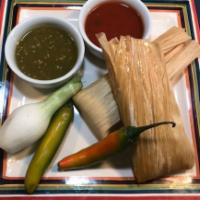 Tamales Plate · 2 pork tamales wrapped and steamed in a corn husk, topped with our zesty tomatoes, queso sau...