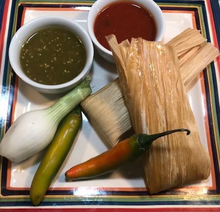 Tamales Plate · 2 pork tamales wrapped and steamed in a corn husk, topped with our zesty tomatoes, queso sauce, sour cream, and guacamole served with rice, tortilla chips, salsa Fresca, and your choice of beans.