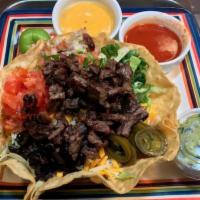 Steak taco salad · Tortilla bowl shell filled with fresh cut lettuce choice of beans and protein. Tomatoes, bla...