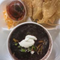 Black Bean Soup · Topped with cheddar cheese, tangy sour cream, and fresh green onions.