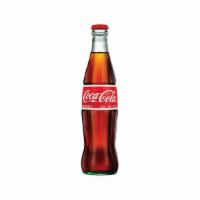 Coca-Cola of Mexico · A 12oz glass bottle of a real sugar alternative to Coca-Cola made in the USA.