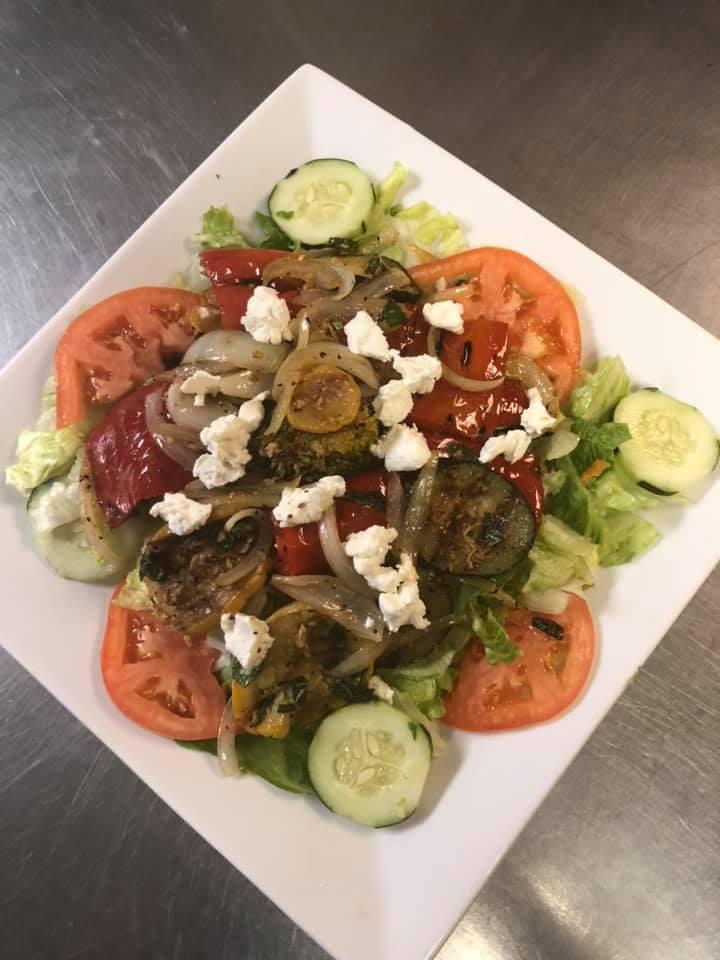 Grilled Vegetable Salad · Includes red pepper, green pepper, broccoli, zucchini, and squash topped with goat cheese.