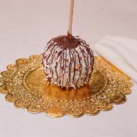 Coconut Almond Caramel Apple · Caramel apple rolled in almonds and coconut, then finished with milk chocolate drizzle.