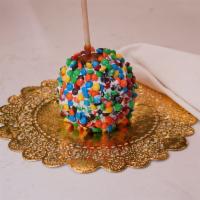Rainbow M&M Caramel Apple · Caramel apple dunked in white chocolate then rolled in colorful M&Ms and finished with a whi...