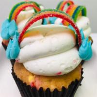 Rainbow Confetti · Vanilla bean cake with rainbow sprinkles. Iced with buttercream topped with rainbow candy st...
