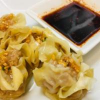 Chicken Dumplings · 6 pieces. Steamed dumplings filled with seasoned chicken, bamboo shoots, carrots and green p...