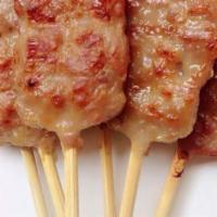 Moo Ping · Skewers of pork marinated in Thai cilantro, garlic sauce. Served with special sauce.