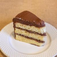 Slice: Yellow Cake with Fudge Frosting · Same fudge frosting as our chocolate cake, but with our fluffy and delicate yellow cake on t...