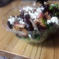 Roasted Beet Salad · Roasted Beets are tossed in aged balsamic with apple and walnut.  Served on top of mixed gre...