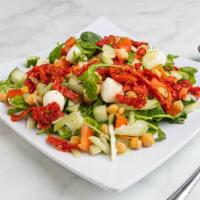 Mediterranean Salad · Arugula, sun-dried tomatoes, heart of palm, tomato, cucumber, celery, mozzarella cheese and ...