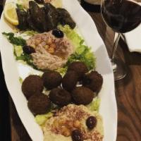 Mezza Platter · Humos, babagnoush, tabuleh, grape leaves, falafel,
Mediterranean dip 