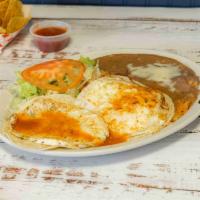 Huevos Rancheros · 2 fried eggs well done smothered with ranchero sauce served with rice, beans, cheese, lettuc...