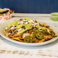 Super Nachos Plate · Any meat, chips, refried beans, cheese, sour cream, avocado, and jalapenos.