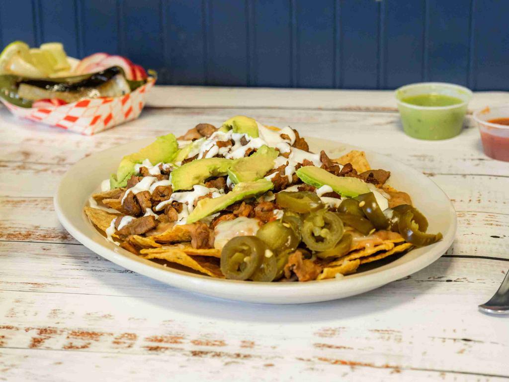 Super Nachos Plate · Any meat, chips, refried beans, cheese, sour cream, avocado, and jalapenos.