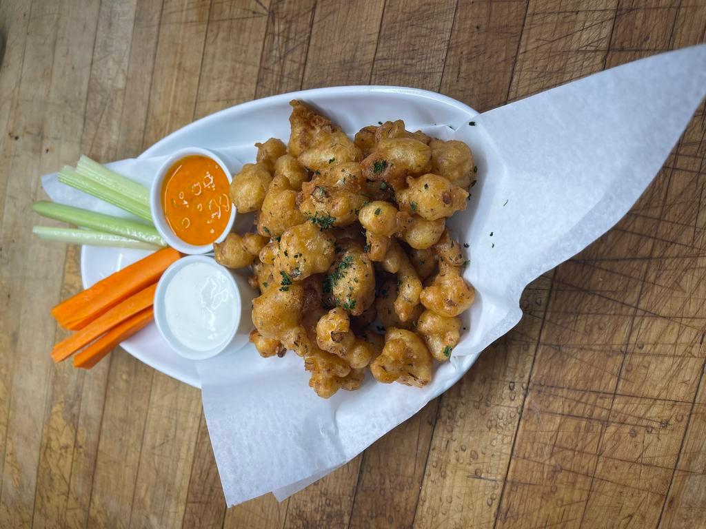 Buffalo Cauliflower · Cajun battered fish cauliflower drizzled with Myrna's spicy buffalo sauce, served with carrot, celery sticks and ranch dipping. Vegan.