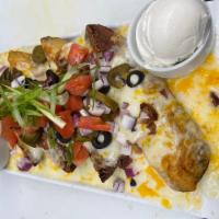 Nacho Potato Skins · Fresh potato nachos loaded with melted cheese, bacon crumbles, black olives and pickled jala...