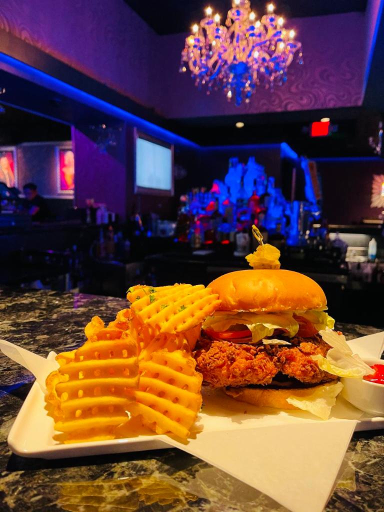 The Southern Chick · Hand battered, crispy fried chicken breast on a toasted brioche bun served with lettuce, tomato, onion, mayo and side of waffle fries.