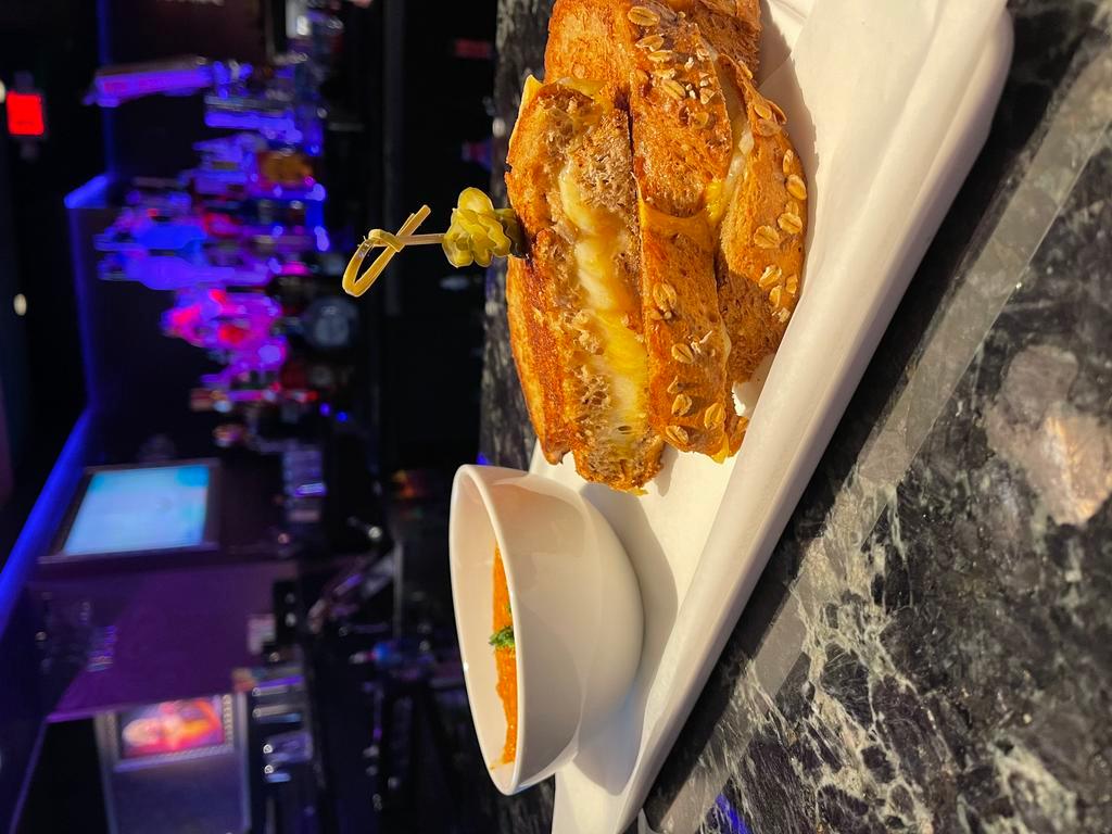 The Glamourous Grilled Cheese  · Thick sliced 5-grain bread overflowing with sharp cheddar and Swiss cheese served with tomato bisque dipping sauce.