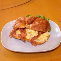 Croissant with Scrambled Eggs and Bacon · Eggs with bacon.