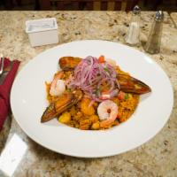 Arroz con Mariscos · Peruvian style seafood mixed with rice served with salsa criolla.