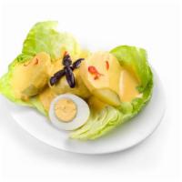 PAPA A LA HUANCAINA · Boiled potato slices topped with Peruvian yellow pepper and cheese sauce.