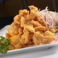 Chicharron De Pescado · Deep fried pieces of fish, topped with criolla sauce and served with fried casava