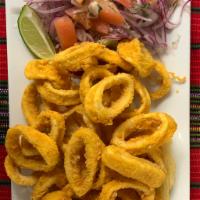 Calamares fritos · Battered calamari rings served with fried Yuca and red onions salad  