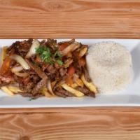 Lomo Saltado · Strips of paper steak sauteed with onions,tomatoes and our Peruvian seasoning served over fr...
