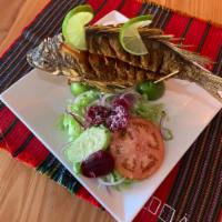 Mojarra Frita · Whole fried fresh tilapia served with two sides  of your choice 