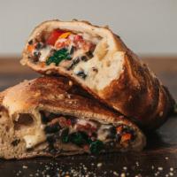 Veggie Me Up Calzone · Start with our dough filled with, spinach, tomato, olives, onion, mushroom, peppers, drop in...
