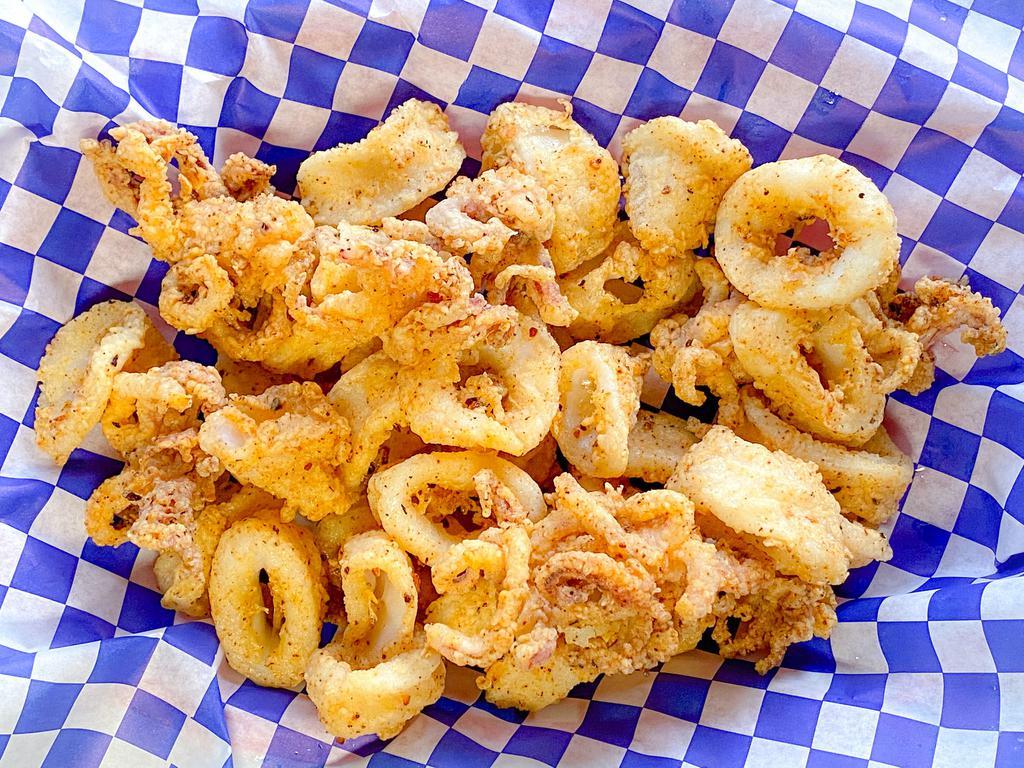 Fried Calamari · Golden crispy fried calamari rings and tentacles served with lemon and our homemade Southwest Chipotle sauce.