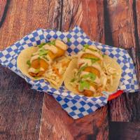Baja Fish Tacos · 2 warm tortillas filled with cabbage, fish, baja sauce and cilantro.