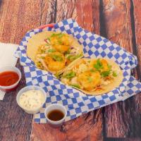 Baja Shrimp Tacos · 2 warm tortillas filled with cabbage, shrimp, baja sauce and cilantro.