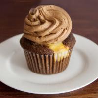 Midnite Cupcake · Chocolate chip cream cheese surprise tucked inside a decadent chocolate cupcake, topped with...