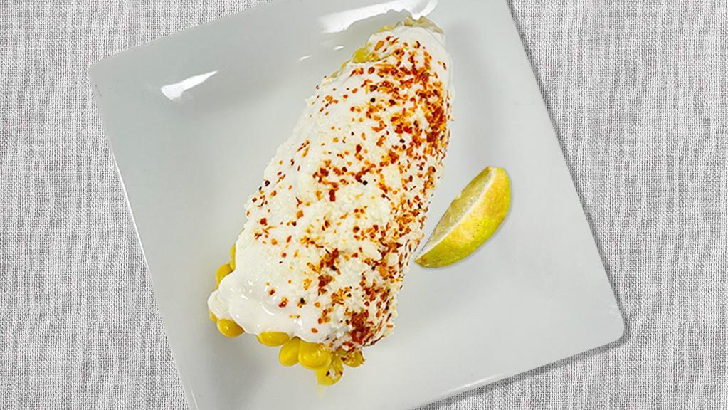 CRAZY CORN · corn on the cob, melted butter, cotija cheese, crema, tajin, lime wedge