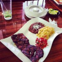 Bistec a la Mexicana · Steak covered sauteed with tomato, onion and jalapeno on the top, served with rice and beans...