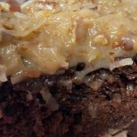German Chocolate Cake · Our rich chocolate cake topped with our homemade German chocolate topping. Just so good!