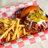 The Red Barn Burger · USDA patty, BBQ pulled pork, pepper jack cheese, bacon, pickled jalapenos, and coleslaw on a...