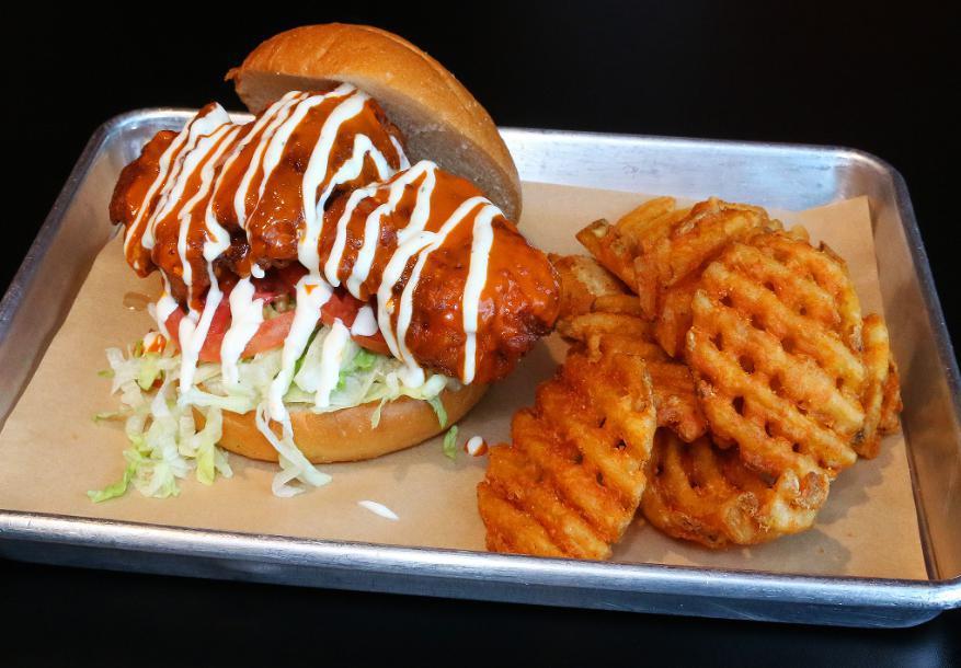 Buffalo Chicken Sandwich · Battered chicken thigh, Korean Buffalo sauce, lettuce, tomato, and ranch. Served with waffle fries. (can substitute grilled chicken breast)