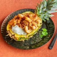 Hawaiian Stewed Shrimp · Tiger shrimp simmered in a spiced pineapple garlic sauce served on a bed of rice nestled awa...
