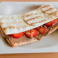 Almond Berry Flatbread Sandwich · Flatbread Sandwich with Almond butter, Strawberry, Honey, and Hemp Seeds.
