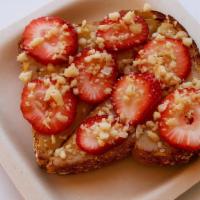 Lilikoi Butter · Multi Grain Toast topped with Lilikoi Butter, Strawberry, and Macadamia Nuts.