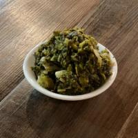 Callaloo · A Jamaican staple, similar to spinach and seasoned with spices and onions