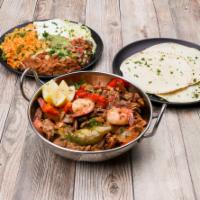 Fajitas San Miguel · Chicken, steak and shrimp.
Served with rice,beans,lettuce,cheese,pico,guacamole 