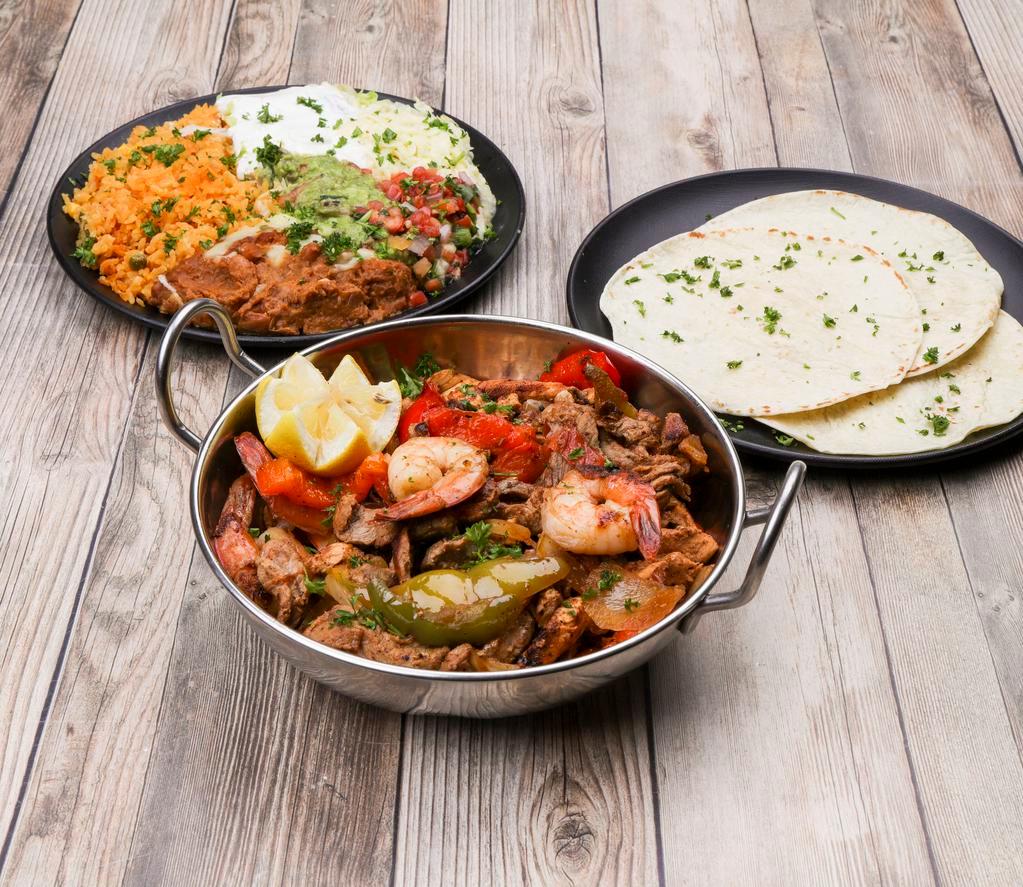 Fajitas San Miguel · Chicken, steak and shrimp.
Served with rice,beans,lettuce,cheese,pico,guacamole 