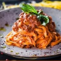 Fettucine Bolognese · Homemade fettuccine in a meat sauce 